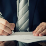 man writing onpaper